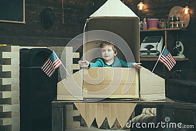 Travel and adventure. Small boy play in paper rocket, childhood. Earth day concept. Dream about career of cosmonaut Stock Photo