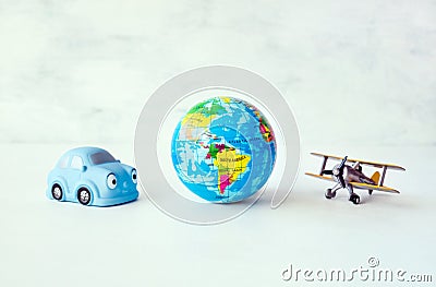 Travel, adventure, vacation concept. Toy yellow air plane, blue Stock Photo