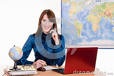 Travel agency employee is talking to a customer on the phone Stock Photo