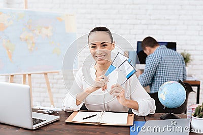 The travel agent keeps tickets for the plane in the travel agency. Stock Photo