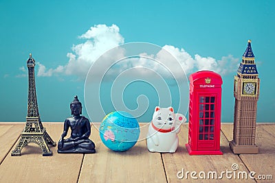 Travel around the world concept. Souvenirs from around the world on wooden table over blue sky background Stock Photo