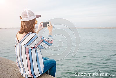 Travel background young women sit alone bridge hold mobile phone Stock Photo