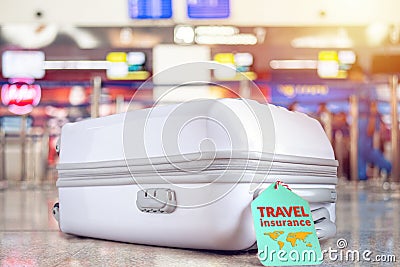 travel bag at the airport with travel insurance tag on suitcase holder for cover delay or lost luggage, trip cancellation Stock Photo