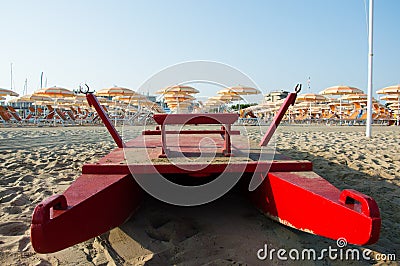 Travel beach Romagna - beach and sea in Rimini with red rescue boat Stock Photo