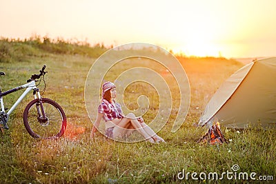 Travel with bicycle alone - young woman in the tent Stock Photo