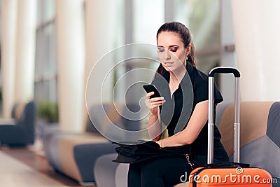 Woman Reading Phone Messages in Airport Waiting Room Stock Photo