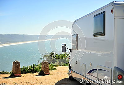 Travel camper van parking over the sea Stock Photo