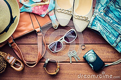 Travel Clothing accessories apparel along for women on wood. Stock Photo