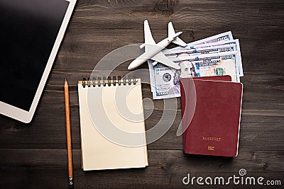 Travel concept with paper note book and pocket money on wood table background Stock Photo