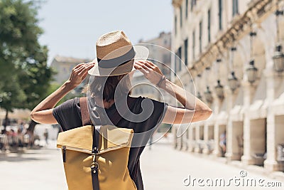 Travel concept, beautiful traveler woman walking in Corfu old town during vacation, cheerful student girl traveling abroad Stock Photo