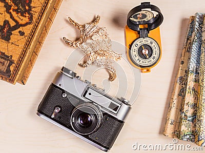 Travel concept. Compass, retro photocamera and cockleshell on a wooden backgroun Stock Photo