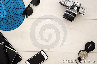 Travel concept flat lay overhead on white wood, with camera and sun glasses Stock Photo