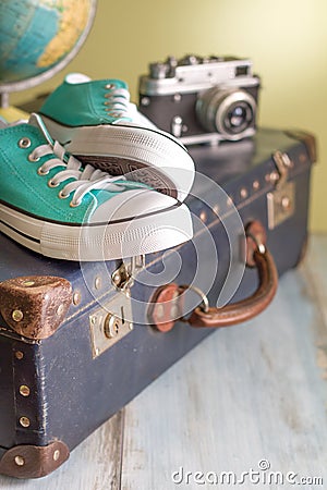 Travel concept with holiday suitcase, shoes and globe Stock Photo