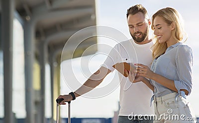 Travel concept. Lovely couple checking tickets outside Stock Photo