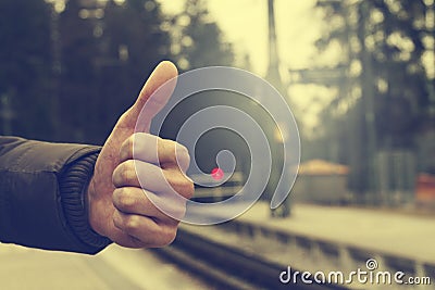 Travel Concept. Making Thumb Up on Nature Background. Road in Ba Stock Photo