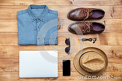 Travel concept shoes, shirt, mobile phone, earphones, laptop, ha Stock Photo