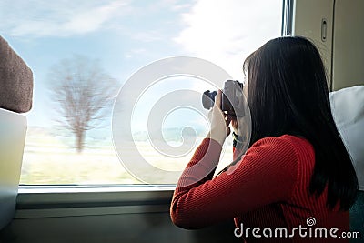 Travel Concept. Young Traveling Woman with Camera taking Photo Stock Photo