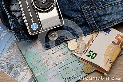 Travel conceptual image of travel passport, money,vintage camera and jeans Editorial Stock Photo