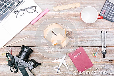 Travel desk with piggy bank for savings, passport and airplane Stock Photo