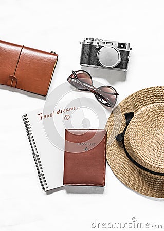 Travel dreams, stay at home. Travel background - passport, straw hat, sneakers, sunglasses and vintage camera on a light Stock Photo
