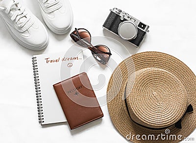 Travel dreams, stay at home. Travel background - passport, straw hat, sneakers, sunglasses and vintage camera on a light Stock Photo