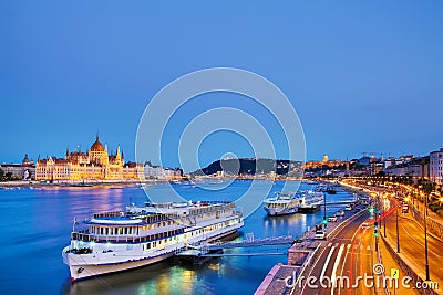 Travel and european tourism concept. Parliament and riverside in Budapest Hungary with sightseeing ships during blue hour sunset Stock Photo
