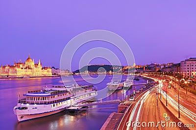 Travel and european tourism concept. Parliament and riverside in Budapest Hungary with sightseeing ships during blue hour sunset Stock Photo