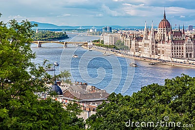 Travel and european tourism concept. Parliament and riverside in Budapest Hungary with sightseeing ships during summer sunny day w Stock Photo