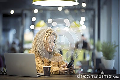 Travel and everywhee office concept with nice adult caucasian woman with technology and coffee - airport gate waiting for the Stock Photo