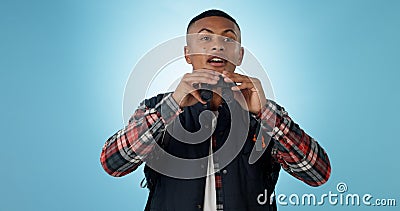 Travel, hiking and man with binocular search in a studio with freedom, adventure or adventure on blue background Stock Photo