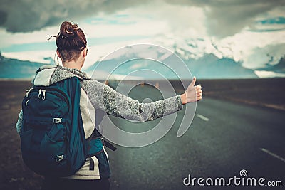 Travel hitchhiker woman walking on a road Stock Photo