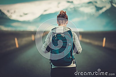 Travel hitchhiker woman walking on a road Stock Photo
