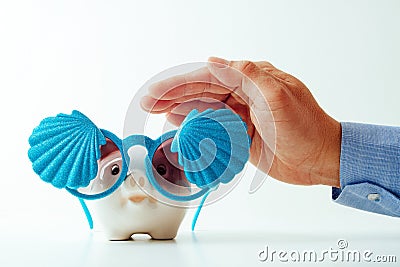 Travel insurance concept.business insurance agent hand in gesture of protection of piggy bank with shell sunglasses on white back Stock Photo