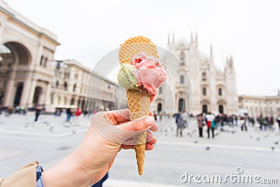 Travel, Italy and holidays concept - Ice cream in front of Milan Cathedral Duomo Stock Photo