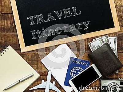 Travel itinerary handwritten with white chalk on a blackboard decorate with plane model, passport, money wallet , notebook Stock Photo