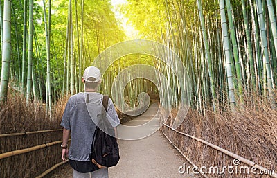 Travel in Japan, a man with backpack travelling at Arashiyama bamboo forest, famous travel destination in Kyoto Japan Stock Photo