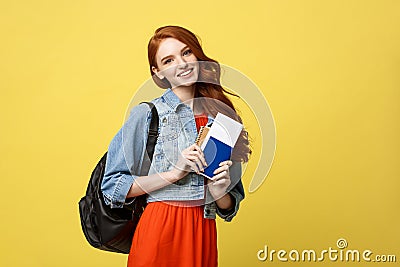 Travel and Lifestyle concept: Full length studio portrait of pretty young student woman holding passport with tickets Stock Photo