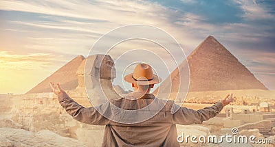 Travel man in hat background pyramid of Egyptian Giza and Sphinx, sunset Cairo, Egypt Stock Photo