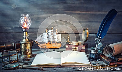 Travel and nautical theme grunge background. Old book, compass, telescope, divider, coins, shell, map, hourglass, quill pen on Stock Photo