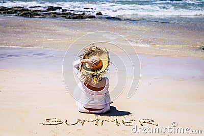 Travel people and summer at the beach concept - outdoor holiday vacation leisure activity - woman with hat and white dress viewed Stock Photo