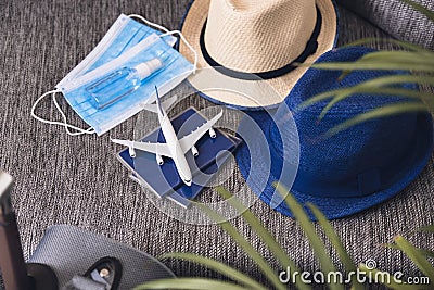 Travel after quarantine Passports, hats, face masks and hand sanitizer Flight rules during coronavirus pandemic. Stock Photo