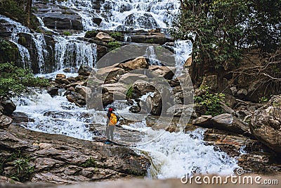 Women travel relax waterfall. In the winter. at the waterfall mae ya chiangmai in thailand. Natural background waterfall. travel Stock Photo