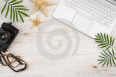 Travel search concept. Copyspace, vintage camera and computer top view Editorial Stock Photo