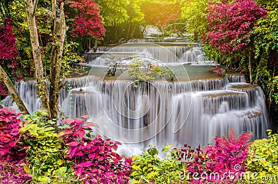 Travel to the beautiful waterfall in tropical rain forest, soft water of the stream in the natural park at Kanchanaburi, Thailand Stock Photo