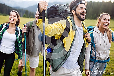 Travel, tourism, hike, gesture and people concept - group of smiling friends with backpacks Stock Photo