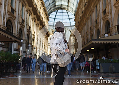 Travel tourist woman near Vittorio Emanuele gallery and Duomo di Milano - cathedral church of Milan in Italy. Blogger girl Stock Photo