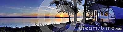 Travel trailer camping by the Mississippi river at sunset in Illinois Stock Photo