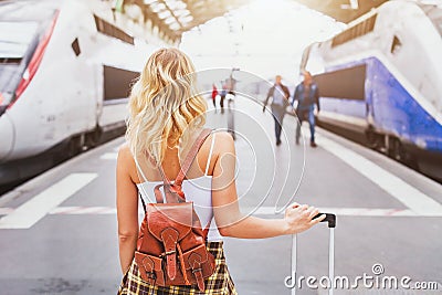 Travel by train, woman passenger with suitcase Stock Photo