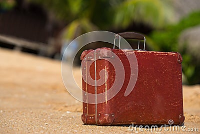 Travel vintage suitcase is alone on a beach Stock Photo