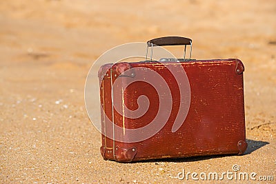 Travel vintage suitcase is alone on a beach Stock Photo